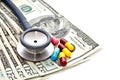 Stethoscope, medicine capsules and banknotes Royalty Free Stock Photo