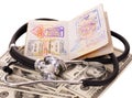 Stethoscope, money and passport. Royalty Free Stock Photo