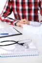 Stethoscope next to hand of doctor reassuring her male patient. Medical ethics and trust concept Royalty Free Stock Photo