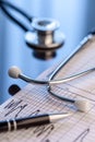Stethoscope on a notebook. Medical cardiogram Royalty Free Stock Photo