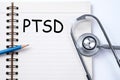 Stethoscope on notebook and pencil with PTSD - post traumatic st Royalty Free Stock Photo