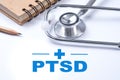 Stethoscope, notebook and pencil with PTSD - post traumatic stress disorder words. Medical concept. War veteran mental health iss Royalty Free Stock Photo