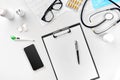 Stethoscope in the office of doctors.Top view of doctor`s desk table, blank paper on clipboard with pen. Copy space Royalty Free Stock Photo