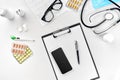 Stethoscope in the office of doctors.Top view of doctor`s desk table, blank paper on clipboard with pen. Copy space Royalty Free Stock Photo