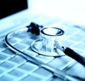 Stethoscope over laptop keyboard Royalty Free Stock Photo