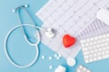 Stethoscope, paper with cardiogram, scattered pills, red heart and keyboard