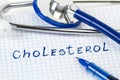 A stethoscope on a paper with cholesterol word write in it