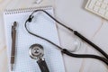Stethoscope with paper notebook and keyboard computer in the medicine help consultation on marble table background Royalty Free Stock Photo