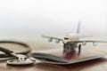 Stethoscope , passport document and airplane: Medical Travel concept