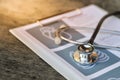 Stethoscope and pen on report pad ,health and medical insurance concept Royalty Free Stock Photo