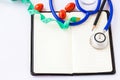 Stethoscope,pencil and measuring tape with tomato on white background