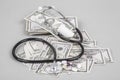Stethoscope and pills on American Dollars Royalty Free Stock Photo