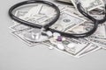 Stethoscope and pills on American Dollars Royalty Free Stock Photo