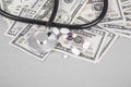 Stethoscope and pills on American Dollars Royalty Free Stock Photo