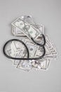 Stethoscope and pills on American Dollars Royalty Free Stock Photo