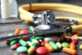 Stethoscope and pills on grey table, closeup. Royalty Free Stock Photo