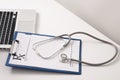 Stethoscope, pills, laptop on white background. Medicine concept Royalty Free Stock Photo