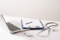 Stethoscope, pills, laptop on white background. Medicine concept Royalty Free Stock Photo