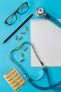 Stethoscope, pills, pen, notebook on the doctor desk Royalty Free Stock Photo