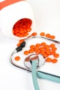Stethoscope, pills and pillbox on white background