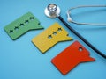 Stethoscope and plates with stars as symbol of patient experience assessment. Royalty Free Stock Photo