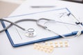 Stethoscope, prescription clipboard and bottle of pills on white Royalty Free Stock Photo