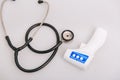 Stethoscope, pulse oximeter and thermometer gun on white background. Phonendoscope. Infrared isometric thermometer gun