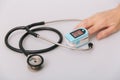 Stethoscope, pulse oximeter and thermometer gun on white background. Phonendoscope. Infrared isometric thermometer gun