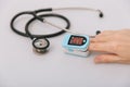 Stethoscope, pulse oximeter and thermometer gun on white background. Phonendoscope. Infrared isometric thermometer gun