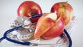 Stethoscope with red apples on a white background Royalty Free Stock Photo