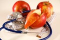 Stethoscope with red apples on a white background Royalty Free Stock Photo