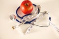 Stethoscope with red apples on a white background Royalty Free Stock Photo