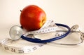 Stethoscope with red apples on a white background Royalty Free Stock Photo