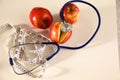 Stethoscope with red apples on a white background Royalty Free Stock Photo