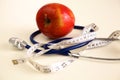 Stethoscope with red apples on a white background Royalty Free Stock Photo