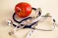 Stethoscope with red apples on a white background Royalty Free Stock Photo