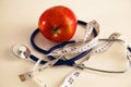 Stethoscope with red apples on a white background Royalty Free Stock Photo