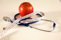 Stethoscope with red apples on a white background Royalty Free Stock Photo