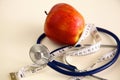 Stethoscope with red apples on a white background Royalty Free Stock Photo