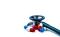 Stethoscope with red and blue antibiotic capsule pills on white table. Antimicrobial drug resistance and overuse. Medical Royalty Free Stock Photo