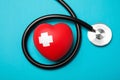 Stethoscope and red heart with adhesive plasters on color background, top view. Royalty Free Stock Photo