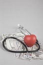 Stethoscope and red heart on American Dollars Royalty Free Stock Photo