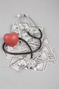 Stethoscope and red heart on American Dollars Royalty Free Stock Photo