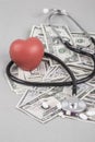 Stethoscope and red heart on American Dollars Royalty Free Stock Photo