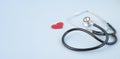 Stethoscope and red heart on a blue background. Greeting background.