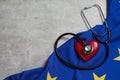 Stethoscope, red heart and flag of European Union on light grey table, flat lay. Space for text Royalty Free Stock Photo