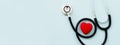 Stethoscope with red heart isolated on blue background, top view. Healthcare and medicine concept Royalty Free Stock Photo