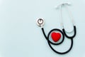 Stethoscope with red heart isolated on blue background, top view. Healthcare and medicine concept Royalty Free Stock Photo