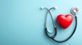 Stethoscope and Red Heart Model on Light Blue, Flat Lay Royalty Free Stock Photo