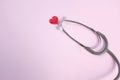 Top view Stethoscope and red heart on pale pink isolated background with copy space for text. Close up, top view. Medical equipme